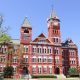 Historic red-brick university building with clock tower