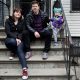 Family sitting on outdoor apartment steps