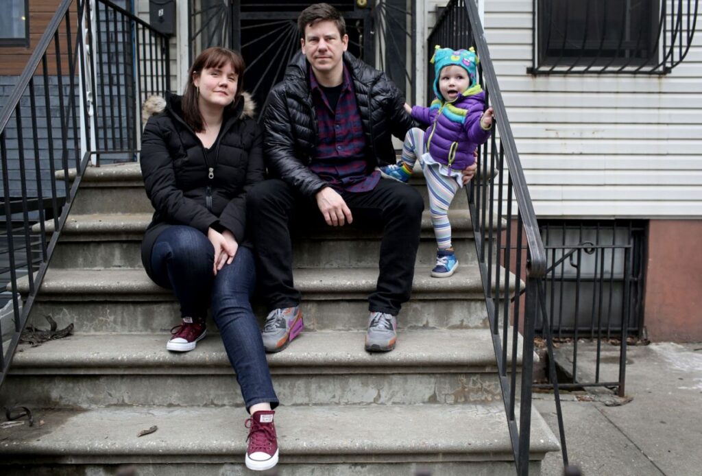 Family sitting on outdoor apartment steps