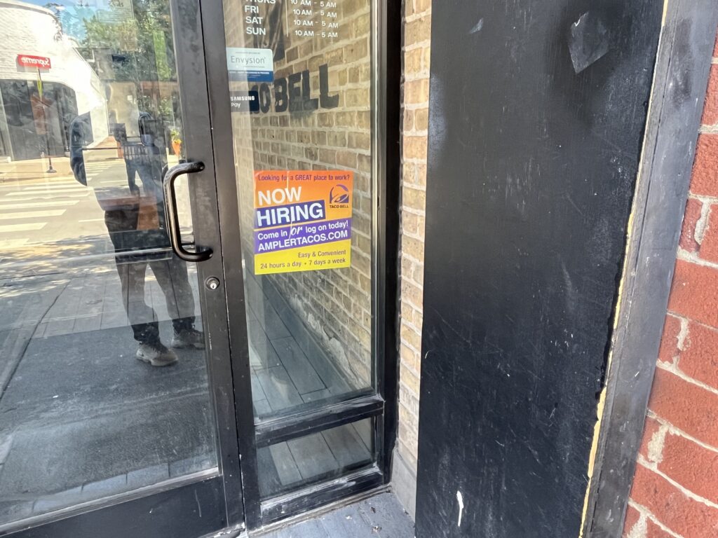 Now Hiring sign on Taco Bell door