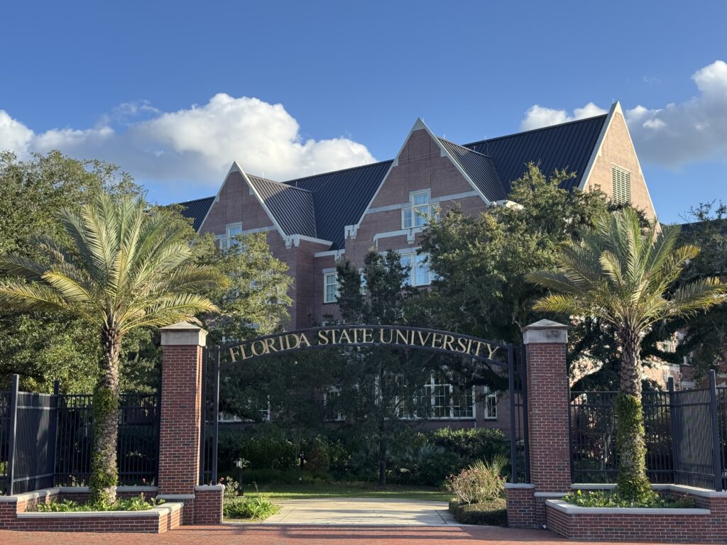 Florida State University entrance with brick building and palms