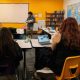 Teacher holding baby in classroom with students