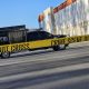 FBI vehicle behind crime scene tape outside warehouse