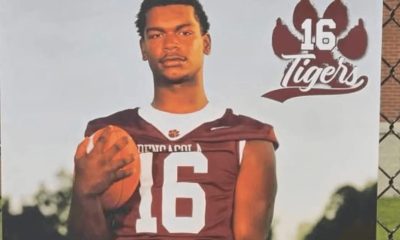 Football player holding ball in Tigers jersey
