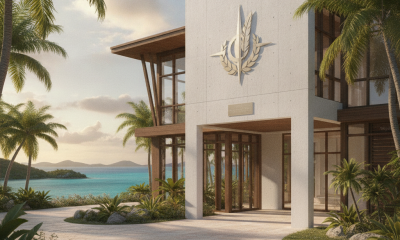 Modern building with a military emblem, surrounded by palm trees and ocean views, proposed — Veterans clinic Saint Thomas
