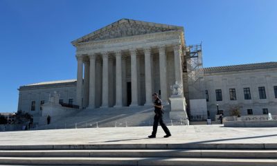 U.S. Supreme Court building with officer walking