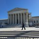 U.S. Supreme Court building with officer walking