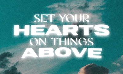 Text graphic featuring the phrase 'Set your hearts on things above' against a cloudy sky background, refl — Colossians 3 1