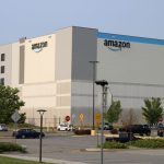 Amazon warehouse exterior with clear sky and parking lot, highlighting the company's logi — FTC Amazon advertising lawsuit