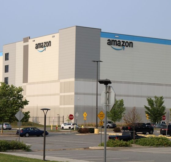 Amazon warehouse exterior with clear sky and parking lot, highlighting the company's logi — FTC Amazon advertising lawsuit