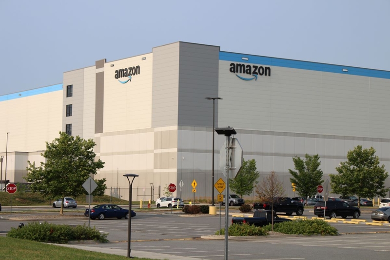 Amazon warehouse exterior with clear sky and parking lot, highlighting the company's logi — FTC Amazon advertising lawsuit