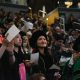 Graduates in caps and gowns celebrating at a commencement ceremony, with a crowd in the backg — DHS H-1B visa fee proposal