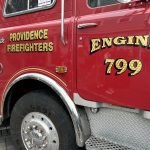 Close-up of a red fire truck with 'Providence Firefighters' and 'Engine 799' lettering. — fire truck price fixing lawsuit