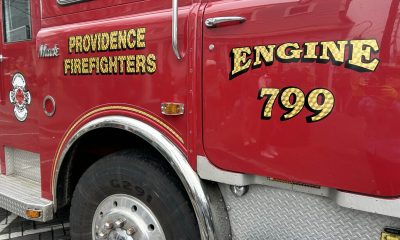 Close-up of a red fire truck with 'Providence Firefighters' and 'Engine 799' lettering. — fire truck price fixing lawsuit