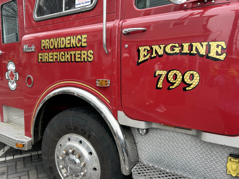 Close-up of a red fire truck with 'Providence Firefighters' and 'Engine 799' lettering. — fire truck price fixing lawsuit