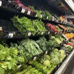 A grocery store produce section filled with various types of lettuce and greens, highlighting multistate food recalls.