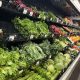A grocery store produce section filled with various types of lettuce and greens, highlighting multistate food recalls.