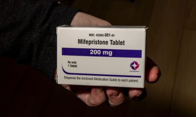 A hand holding a box of mifepristone tablets, labeled 200 mg, with instructions for patients. — mifepristone lawsuit texas