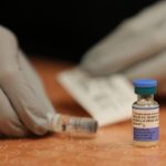 A healthcare worker prepares a measles, mumps, and rubella vaccine vial on a table. — Pennsylvania measles deaths