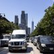 Busy New York City street with traffic and skyscrapers in the background, including One W — New York climate Superfund law