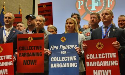 Group of union members holding signs advocating for collective bargaining rights at a rall — labor union membership growth