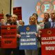 Group of union members holding signs advocating for collective bargaining rights at a rall — labor union membership growth