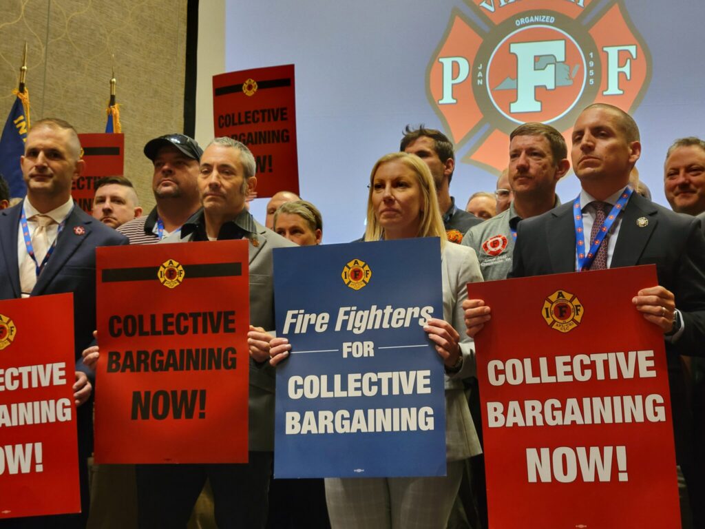Group of union members holding signs advocating for collective bargaining rights at a rall — labor union membership growth