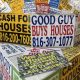 Colorful signs advertising cash home buying services, stacked together, with phone n — Real Estate Wholesaling Regulations