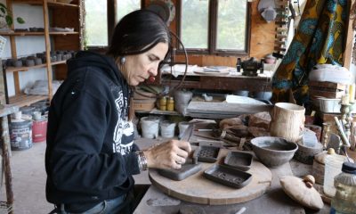 Artist working on pottery in a rustic studio filled with tools and materials. — Alpha-Gal Syndrome Kentucky