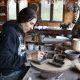 Artist working on pottery in a rustic studio filled with tools and materials. — Alpha-Gal Syndrome Kentucky