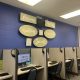 A room with computer workstations and a wall sign reading 'Missouri Reentry Framework for — women on parole mental health