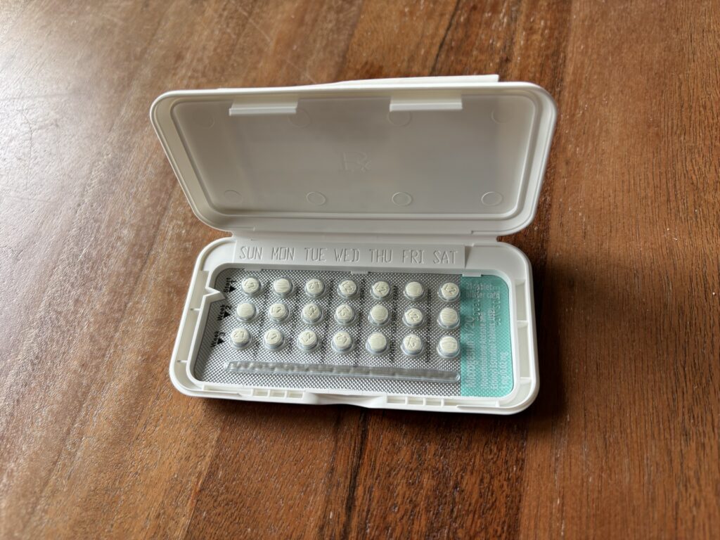 A pack of birth control pills opened on a wooden surface, showing the pills arran — Pennsylvania Title X lawsuit dismissed