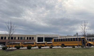 Hammond High School with yellow school buses parked outside under a cloudy sky. — Violent Victimization at School 2024