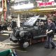 An auto worker in a manufacturing facility assembling a vehicle amid machinery and equip — Trump Canada trade war midterms