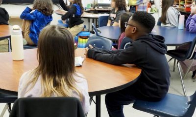 Students attentively listening in a classroom during a lesson on edu — department of education school monitoring suspended