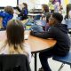 Students attentively listening in a classroom during a lesson on edu — department of education school monitoring suspended