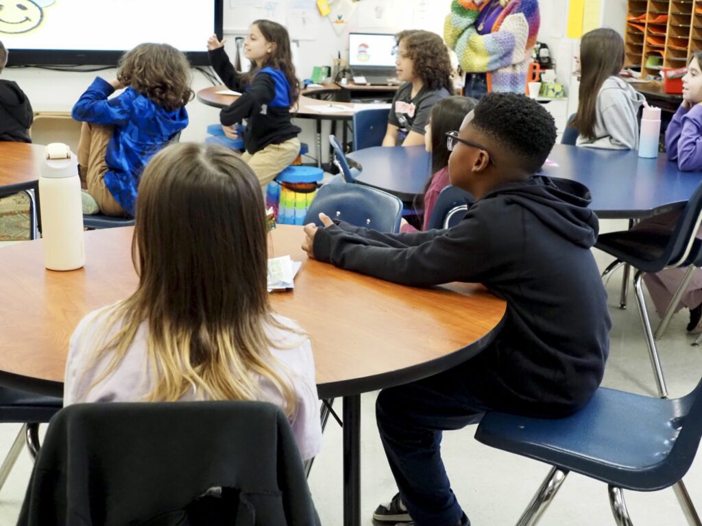 Students attentively listening in a classroom during a lesson on edu — department of education school monitoring suspended