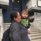 A woman holds a young child outside a building, both smiling, with the number 660 visib — Trump Public Charge Rule Lawsuit