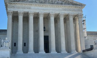 The U.S. Supreme Court building with its iconic columns and steps, under a clear b — Supreme Court mail in voting decision