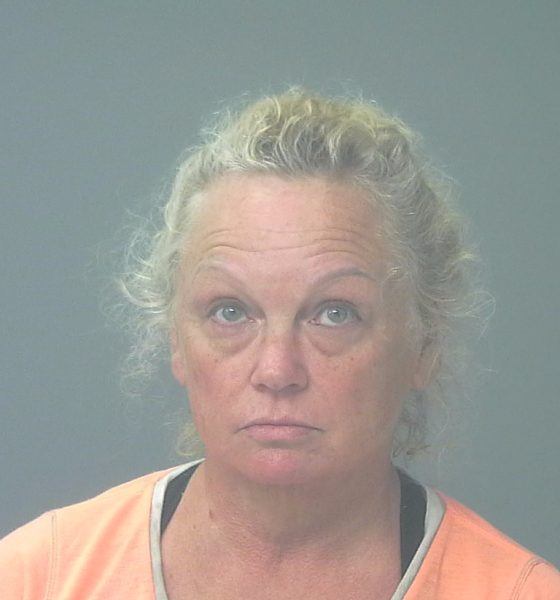 Woman in orange shirt facing camera against gray background — Gulf Breeze animal cruelty arrest