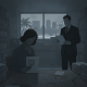A woman and a man in a dimly lit office, reviewing legal documents related to VAWA immigration policy changes.