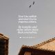 Philippians 2 3 daily bible verse about humility over a gray sky, birds, and tiled rooftops