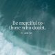 Text from Jude 1:22 encouraging mercy towards those who doubt, with a serene ocean background. — Jude 1 22 meaning