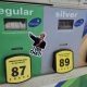 Gas pump displaying fuel prices with a sticker featuring a thumbs-up gesture and text referenc — States Suspending Gas Tax