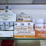 Display of kratom products including extracts and capsules on a retail shelf, highlighting kratom 7-OH laws.