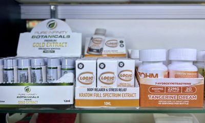 Display of kratom products including extracts and capsules on a retail shelf, highlighting kratom 7-OH laws.