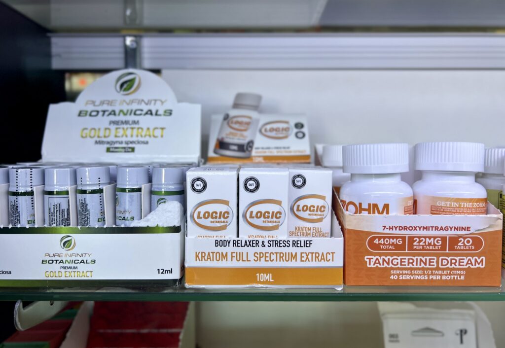 Display of kratom products including extracts and capsules on a retail shelf, highlighting kratom 7-OH laws.