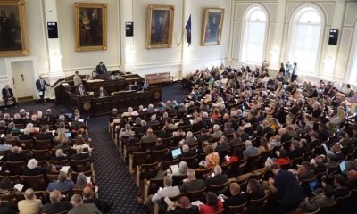 A crowded legislative chamber with numerous attendees and officials dur — state legislative elections competitive chambers