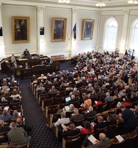 A crowded legislative chamber with numerous attendees and officials dur — state legislative elections competitive chambers
