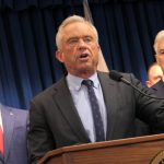 Robert F. Kennedy Jr. speaking at a podium with supporters in the background during a pr — FDA abortion pill safety review